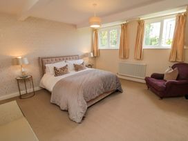A bedroom with a bed and armchair at Scalby Grove Cottage in Scalby