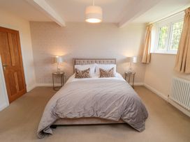 A bedroom with a bed and nightstands at Scalby Grove Cottage in Scalby
