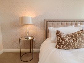 A bedroom with a bed and side table at Scalby Grove Cottage in Scalby