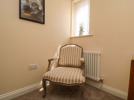 An armchair and radiator in a sitting room at Scalby Grove Cottage Scalby