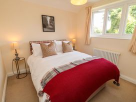 A bedroom with a bed and lamps at Scalby Grove Cottage in Scalby