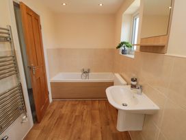 A bathroom with a bathtub and sink at Scalby Grove Cottage in Scalby