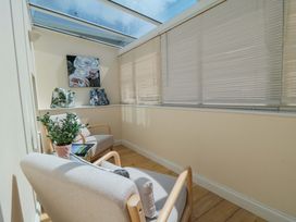 A conservatory with armchairs and a potted plant at Scalby Grove Cottage in Scalby