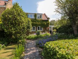 A house with a garden and pathway at Scalby Grove Cottage in Scalby