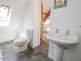 A bathroom with a sink and toilet at Woodpecker Cottage in Llangollen