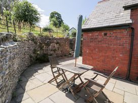 An outdoor area with a table and chairs at Woodpecker Cottage in Llangollen