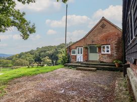 An outdoor view of a brick building with steps and plants at Upper Pandy Farm in Welshpool