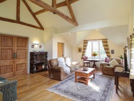 A living room with a table and sofa at Upper Pandy Farm in Welshpool