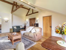 A living room with a sofa and coffee table at Upper Pandy Farm in Welshpool