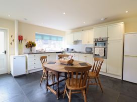 A kitchen with a table and chairs at Upper Pandy Farm in Welshpool
