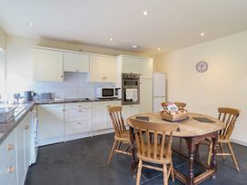 A kitchen with a round table and chairs at Upper Pandy Farm in Welshpool