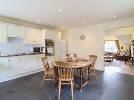 A kitchen with a dining table and chairs at Upper Pandy Farm in Welshpool