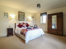 A bedroom with a bed and a wardrobe at Upper Pandy Farm in Welshpool