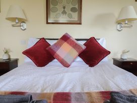 A bedroom with a bed and decorative pillows at Upper Pandy Farm in Welshpool