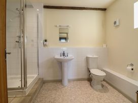 A bathroom with a shower, sink, toilet and bathtub at Upper Pandy Farm in Welshpool
