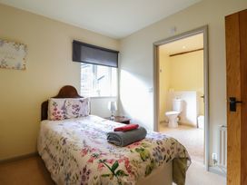 A bedroom with a bed and ensuite bathroom at Upper Pandy Farm in Welshpool