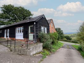 A house with a pathway and trees at Upper Pandy Farm in Welshpool
