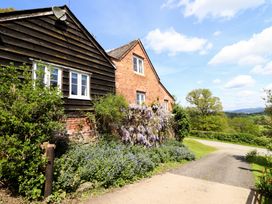 A building with plants and a pathway at Upper Pandy Farm Berriew near Welshpool