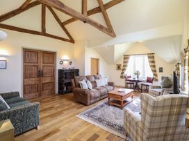 A living room with a sofa and armchairs at Upper Pandy Farm in Berriew near Welshpool