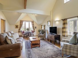 A living room with a sofa and coffee table at Upper Pandy Farm in Berriew near Welshpool
