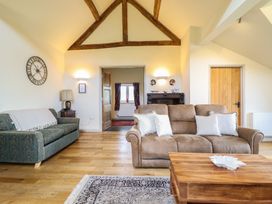 A living room with a sofa and coffee table at Upper Pandy Farm in Berriew near Welshpool
