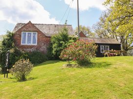 A house with a garden and seating area at Upper Pandy Farm in Berriew near Welshpool