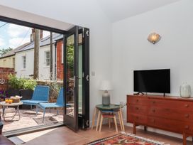 A living room with a television and seating area at Jams in Lympstone