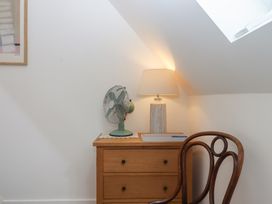A study with a lamp and fan on a drawer unit at Jams in Lympstone