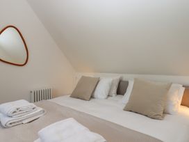A bedroom with a bed and pillows at Jams in Lympstone