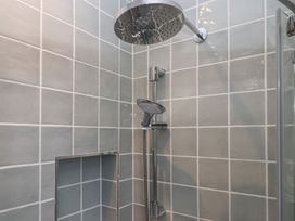 A shower with wall tiles at Jams in Lympstone