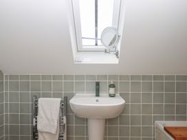 A bathroom with a sink and mirror at Jams in Lympstone