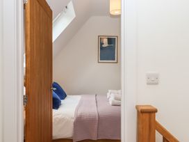A bedroom with a bed and artwork at Jams in Lympstone