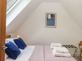 A bedroom with a bed and towels at Jams in Lympstone