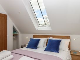 A bedroom with a bed and skylight at Jams in Lympstone