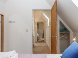 A bedroom with doors leading to other rooms at Jams in Lympstone