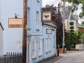 An exterior view of Redwing Bar & Dining with a car park sign in Lympstone