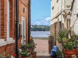 A view between buildings towards water at Jams in Lympstone