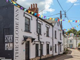 An exterior view of The Globe Inn with colorful bunting in Lympstone