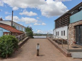 An outdoor area with a paved pathway and buildings at Jams in Lympstone