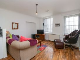 A living room with a couch and a television at Duncan Square in Whitehaven