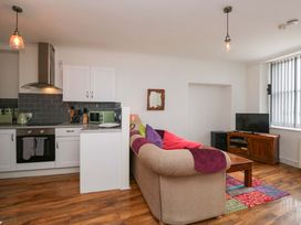 A living room with a kitchenette and a sofa at Duncan Square in Whitehaven