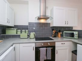 A kitchen with countertop, oven and appliances at Duncan Square in Whitehaven