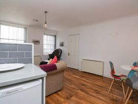 A living room with a sofa and dining table at Duncan Square in Whitehaven