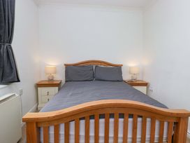 A bedroom with a bed and nightstands at Duncan Square Whitehaven