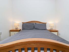 A bedroom with a bed and lamps on nightstands at Duncan Square in Whitehaven