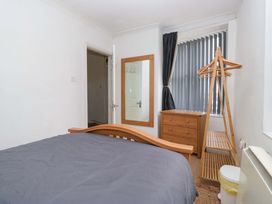 A bedroom with a bed and dresser at Duncan Square in Whitehaven
