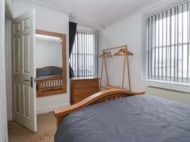 A bedroom with a bed and furniture at Duncan Square in Whitehaven
