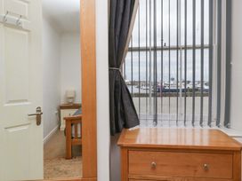 A living room with a window overlooking the marina at Duncan Square in Whitehaven