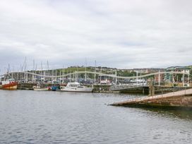 A marina with boats and a bridge at Duncan Square in Whitehaven