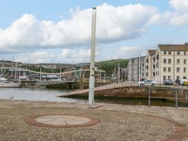 A view of a marina with boats and buildings at Duncan Square in Whitehaven
